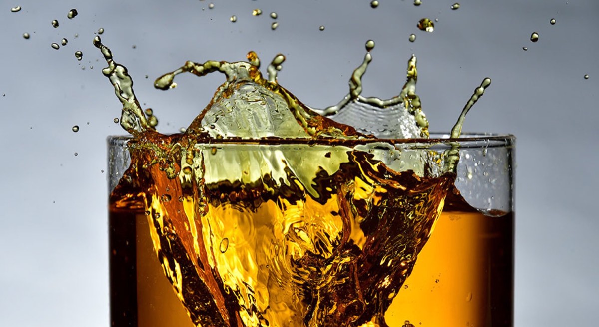 clear drinking glass filled with brown liquid