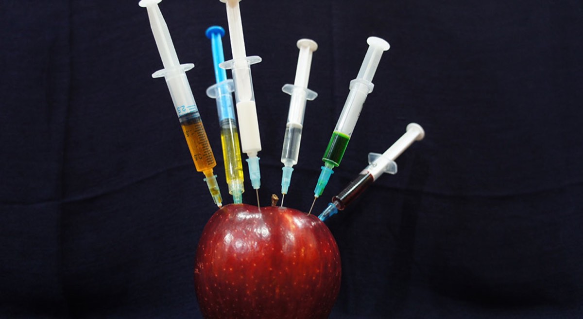 Apple with plastic syringes