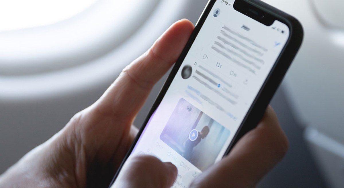 person holding iphone space grey open twitter