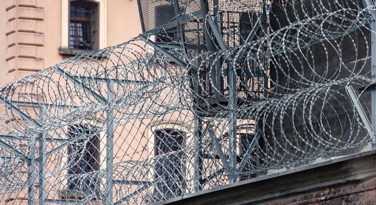gray barbwire on Fence near building