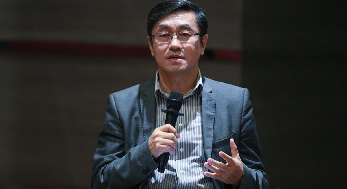 A man in suit with microphone