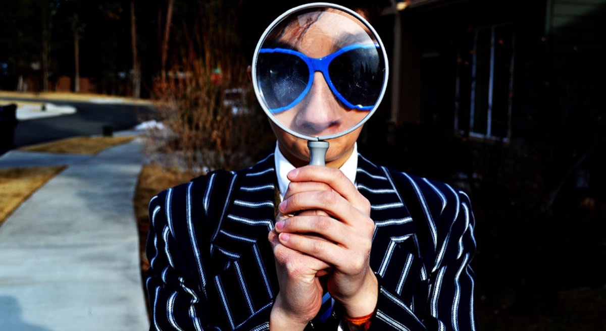 man using magnifying glass